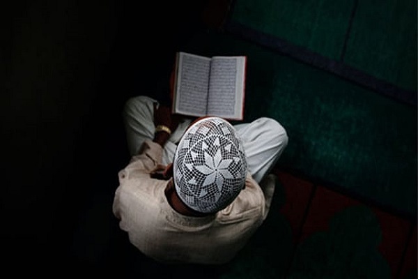 A Pakistani man reads the Quran.