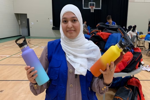 Volunteers fill backpacks with back-to-school supplies for vulnerable youths