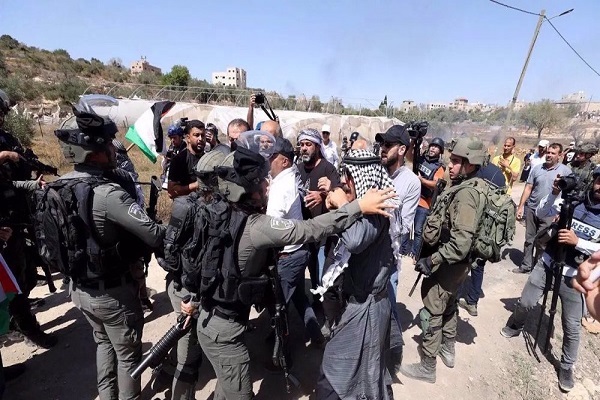 Palestinians confront Israeli troops during a protest against the construction of a settlement in the village of Qaryut near Nablus, September 15, 2023