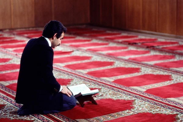 A believer reading the Holy Quran