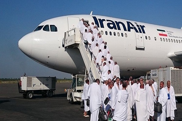 Iranian Umrah pilgrims board an Iran Air plane.