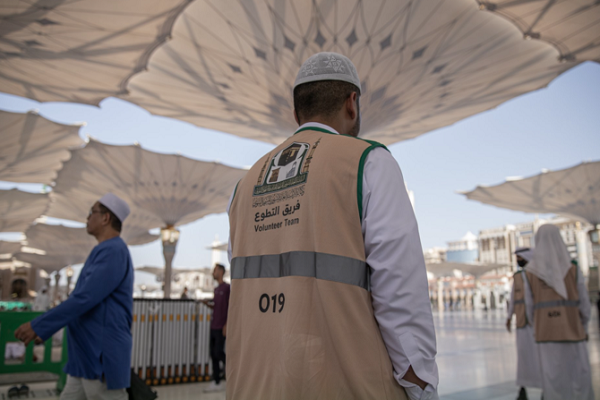 Volunteers help pilgrims and worshippers at the Prophet's Mosque in Medina.
