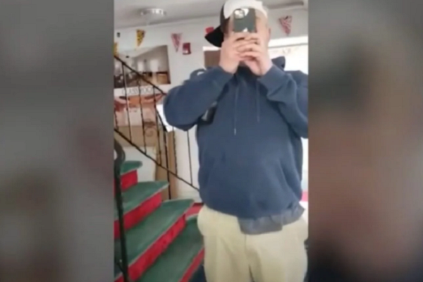 Man enters a mosque in Melville, New York, recording worshipers on Wednesday
