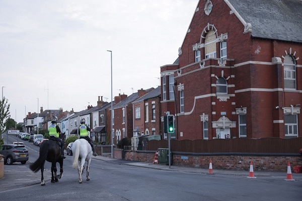 Mounted police officers patrol outside Southport Islamic Centre Mosque after unrest