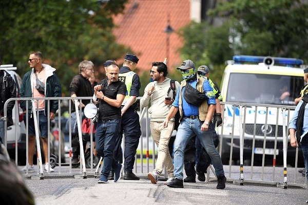 Salwan Momika escorted by police in Stockholm, Sweden