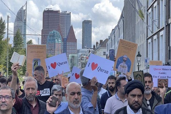 Muslim protestors carry The Holy Quran and banners during a demonstration organized by various Islamic foundations against the attacks on Quran, marching towards the Danish and Swedish embassies at Malieveld Square in The Hague.