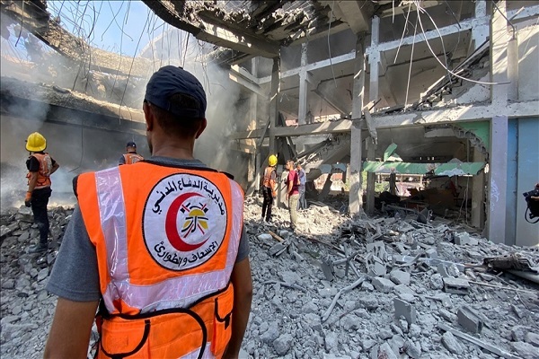 A member of the Gaza civil defense at the site of a building destroyed by Israeli airstrikes