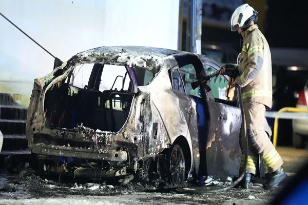 A firefighter putting out a fire outside a mosque in Sussex, southern England (October 4, 2025)