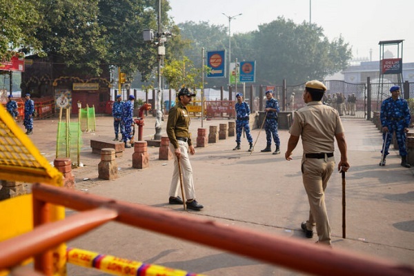 Security personnel stand near the site following an explosion close to the historic Red Fort in New Delhi, India, on November 11, 2025.