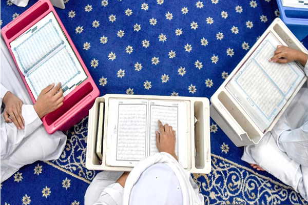 Muslims reading the Quran
