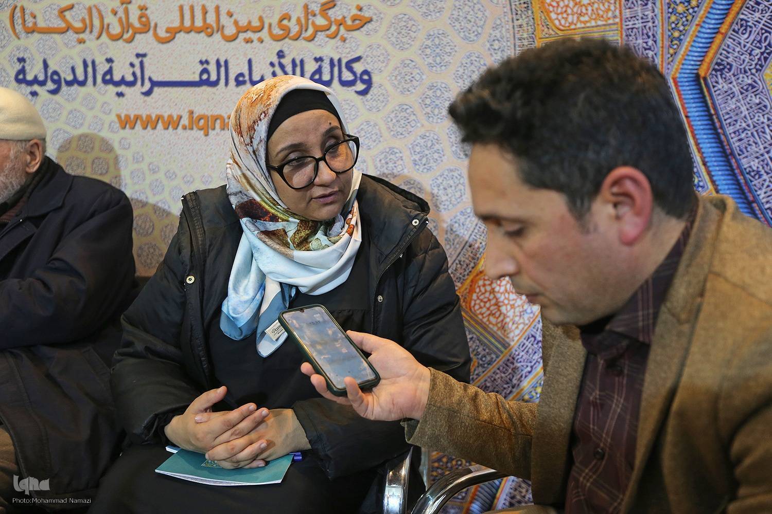 Algerian illumination artist Amal Dhayfallah speaking to IQNA at the 32nd Tehran International Holy Quran Exhibition.