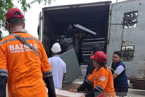 Officers from Indonesia's National Alms Agency (Baznas) unload aid data-x-items for survivors of Myanmar earthquake