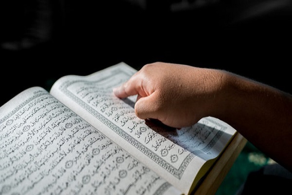 A student reading the Quran