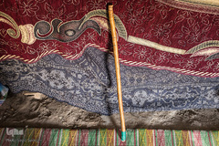 عصای حشمت که از آن به نام تفنگش یاد می‌کند. عصایی که تا پنج سال پیش با آن به سختی می‌توانست راه برود، ولی امروز به خاطر بیماری، پاهای کوچکش توان راه رفتن را ندارد.